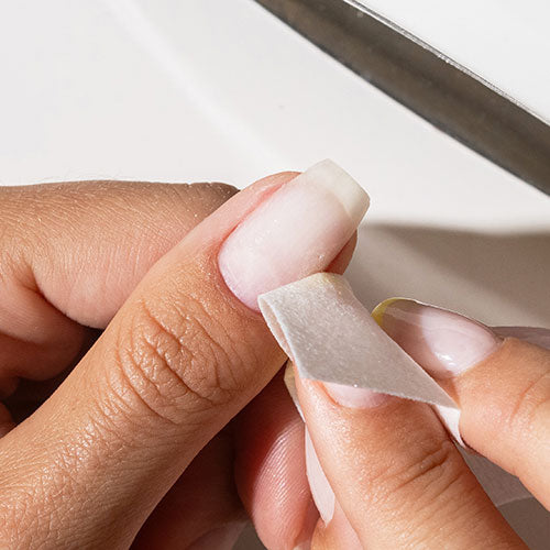 Prepping nails before gel nail polish application - photographed in Australia on model
