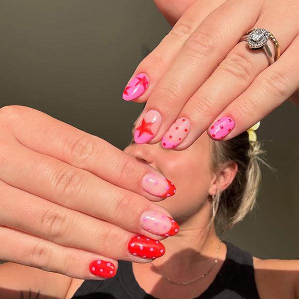 Pink and red polka dot and star gel nail art - Gelous customer photo from Instagram