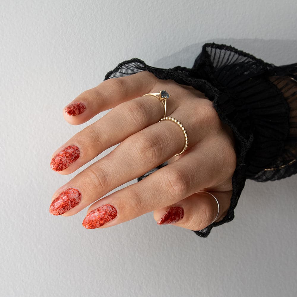 Gelous Red Tinsel gel nail polish on model in Australia