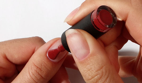 Applying red Gel Nail Polish at home - photographed in Australia