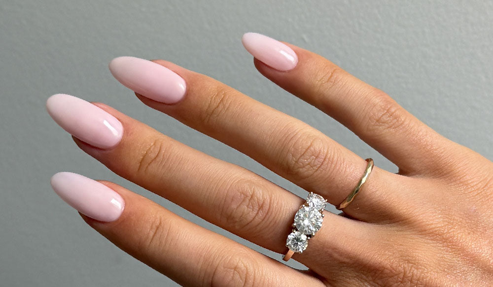 Hand with Angelic Gel Nail Polish and Long Almond Nail Tips on - Applied with Clear Rubber Base Coat - photographed in Australia